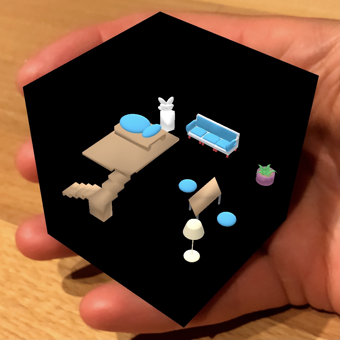 Darstellung eines 3D-Modells in Augmented Reality auf einer Hand. 3D-Modell zeigt Hausinventar